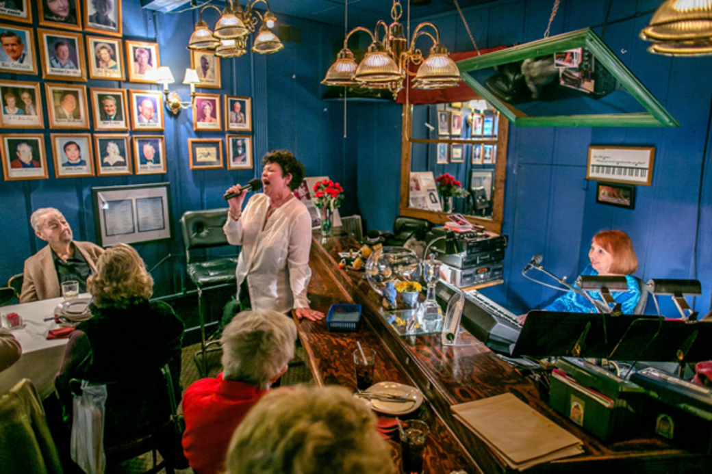 KEY PARTY: Fran Irwin (left) has played piano at McKinnon's Louisiana for 31 years, hosting an open mic frequented by regulars who come to sing old standards.