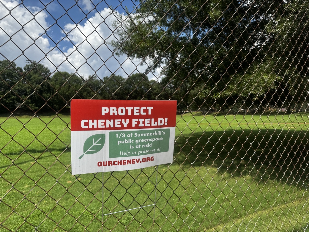 NEIGHBORS ORGANIZE: The green space beyond this fence will be occupied by a three-story building if the Atlanta Track Club has its way.