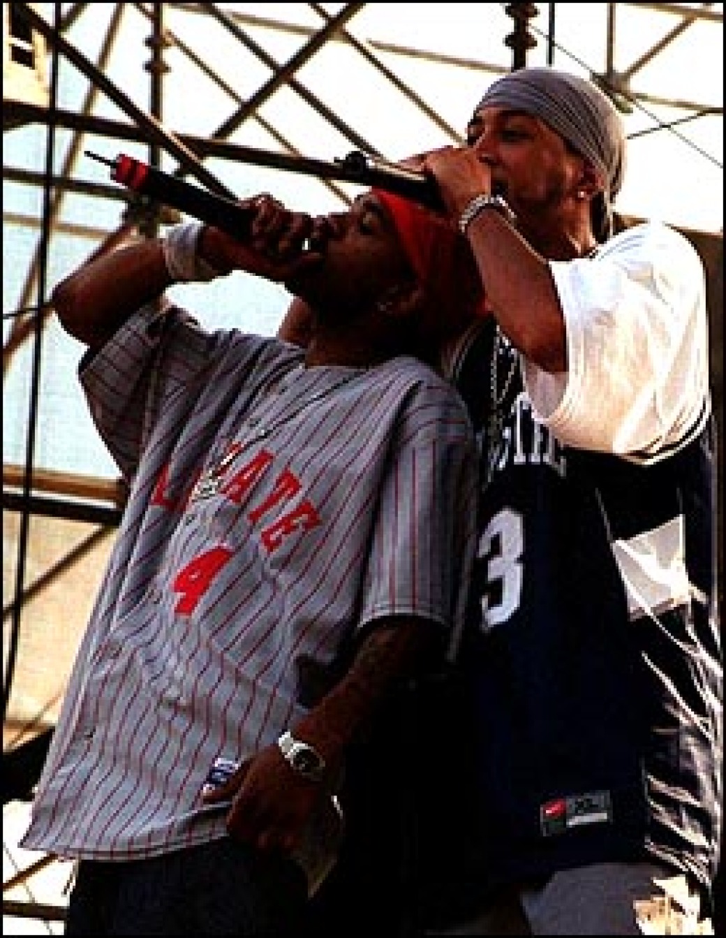 Atlanta rapper Ludacris (right) and member of his posse throw them 'bows for the hometown crowd, Sunday on the V103 Stage.