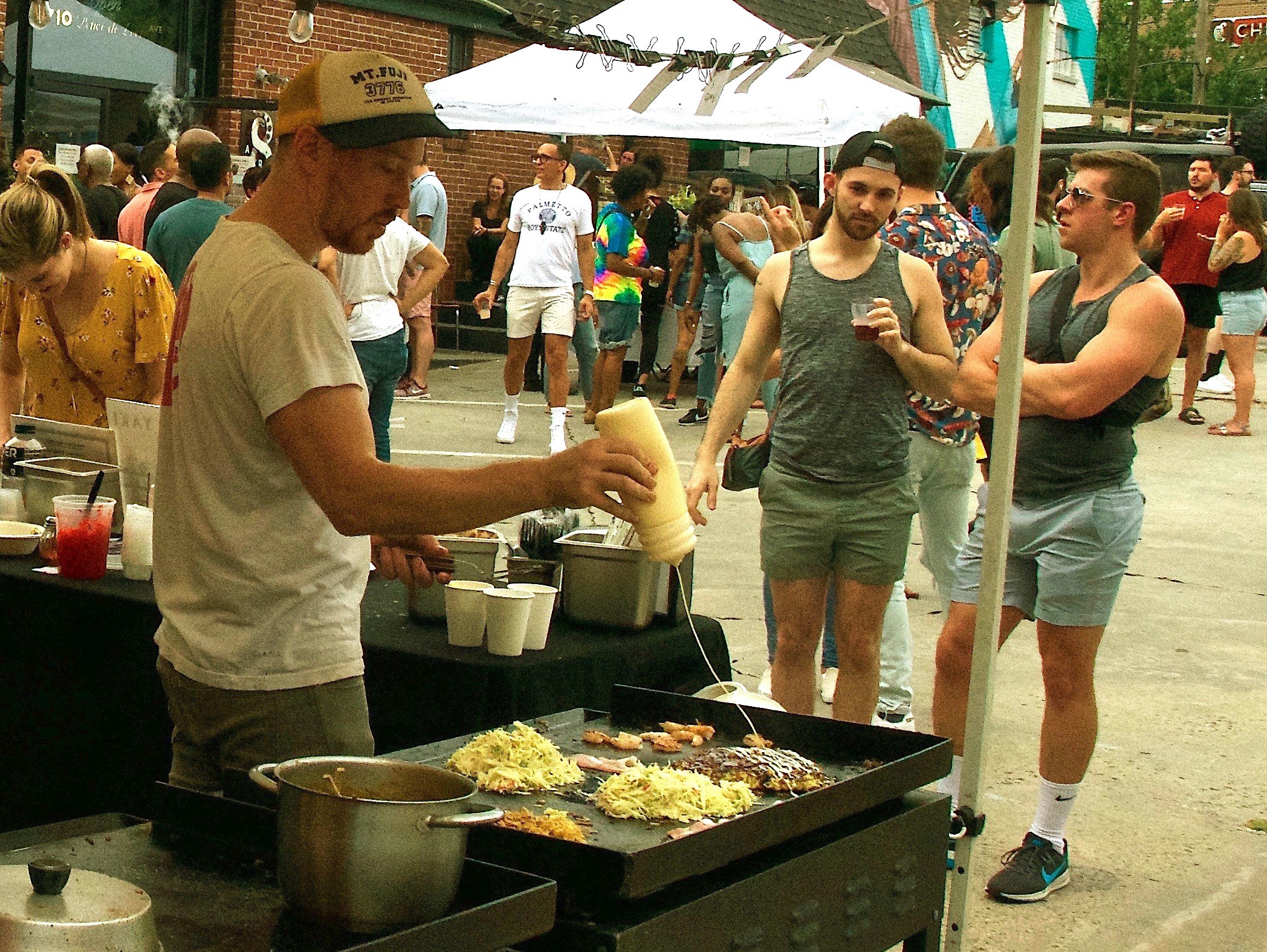 Corban Irby slinging sauce for Japanese street food pop-up, Ok Yaki. Photo by Ema Carr.