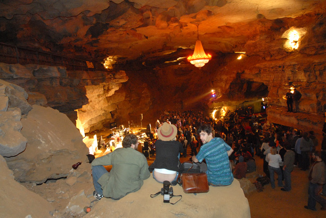 People sat on rocks on multilevels inside the Volcano Room to enjoy the show.