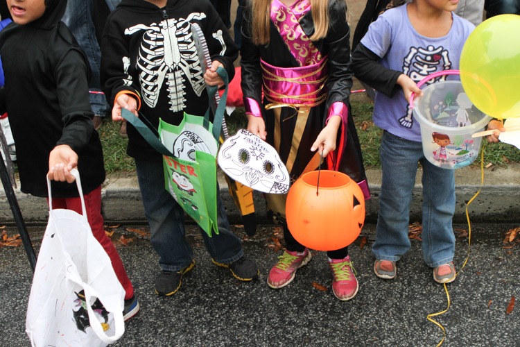 Children lined the streets with all sorts on containers ready to grab any and all candy thrown at them throughout the day.