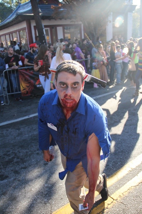 A Murder Kroger employee limps through the parade.