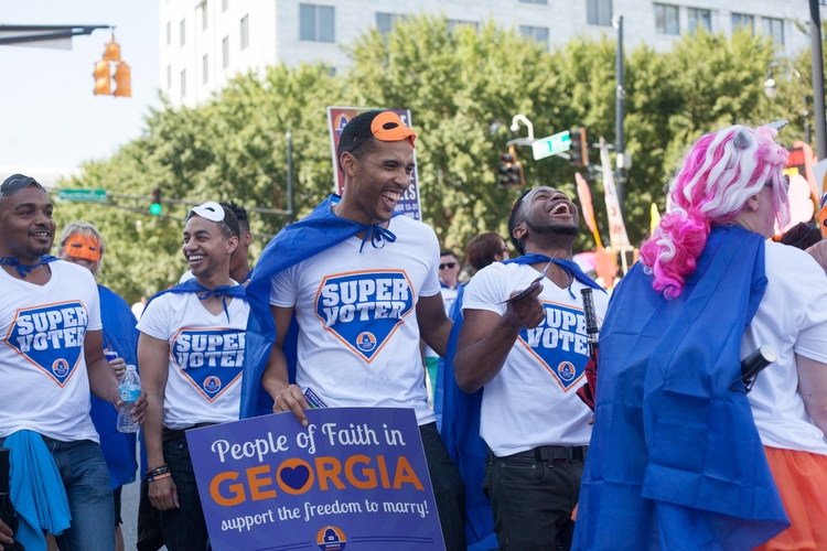 Members of Georgia Equality laugh as they walk in the parade.
