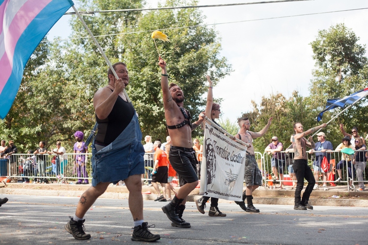 A group from Rawhide Leather walks down 10th Street.