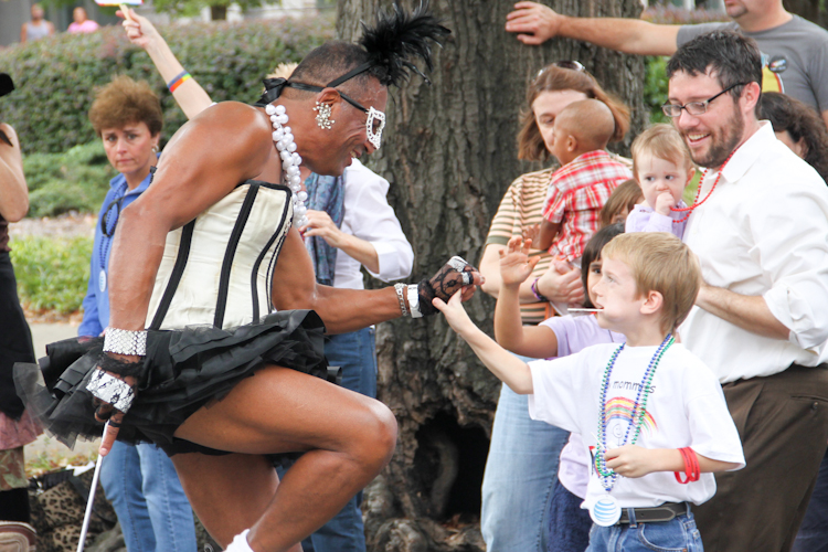 Baton Bob gives a high-five to boy who ran into the parade to greet him.