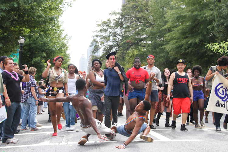 Two men drop to the ground at the end of their vogue dance routine.