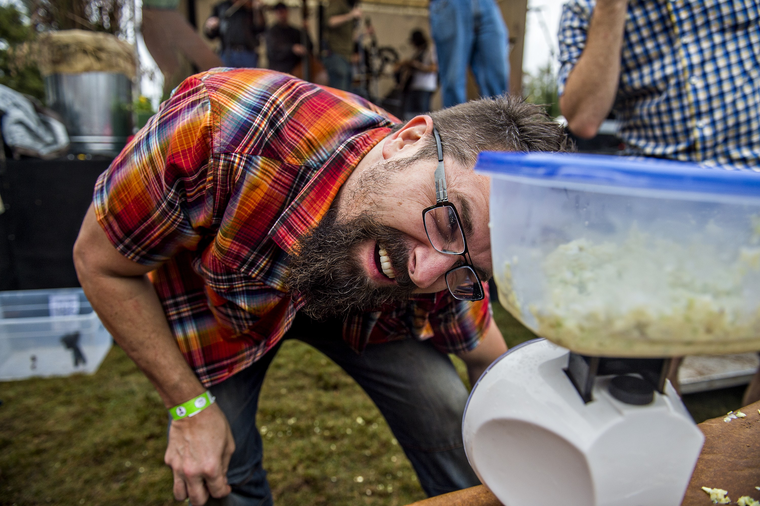 Photo: Jonathan Phillips. Josh Minter weighs the remaining cole slaw in a bucket to try and determine a winner of the cole slaw eating contest. 