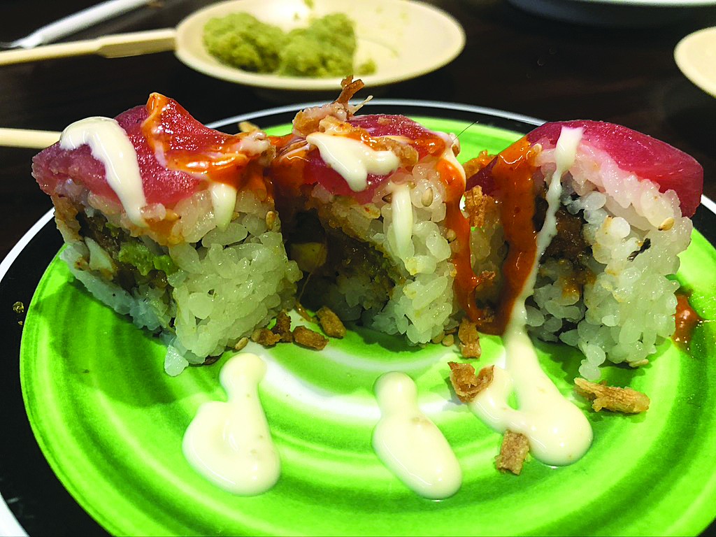 ROLL WITH THIS: Generally, I found the rolls tastier than the nigiri at Kura, probably because of the mix of flavors. I think you can see, though, that either the knife work or the condition of the fish itself don’t present the meaty slices you get at a conventional sushi bar like, say, Publix. That was mean. I remind you that this is regarded as fast food.. Photo by Cliff Bostock.