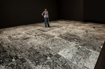 Ambulatório (Outpatient Ward or Walking Place)’: In the 1994 installation by Oscar Muñoz, viewers encounter an aerial photograph covered with tempered sheet glass that fractures underfoot. Six works by Muñoz will be exhibited at the Zuckerman Museum of Art Aug. 27-Dec. 10. PHOTO CREDIT: Courtesy of the artist and Sicardi Ayers Bacino, Houston, TX