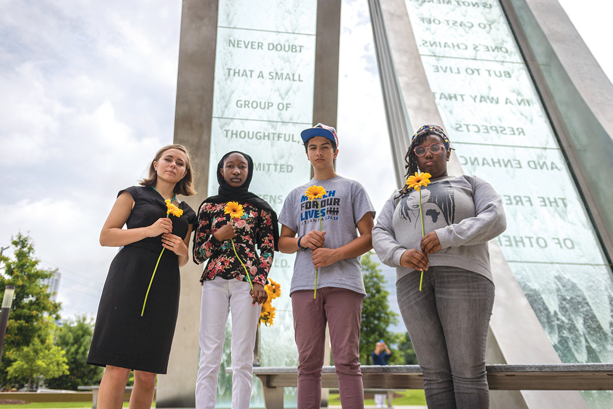 NEVER DOUBT: Adrina Bradley, Nurah Abdul Hawk, Royce Mann and Lyric Gaskell of March for Our Lives - Atlanta at the Passage Water Sculpture on the grounds of the Center for Civil and Human Rights. Photo by Ian Marceda AND Jacob Ross.