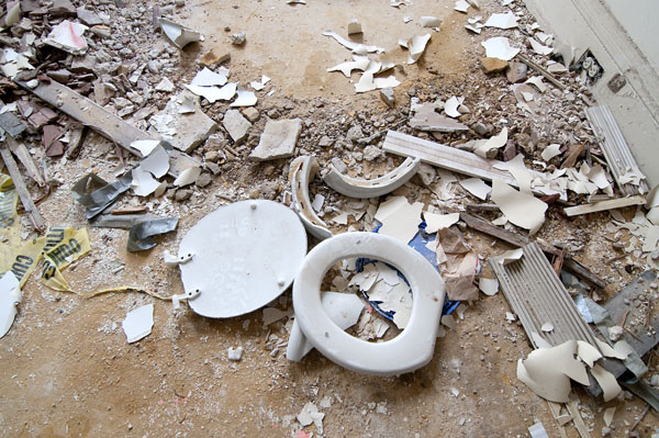 A toilet seat rests amid rubble in a first floor room. Photo by Joeff Davis