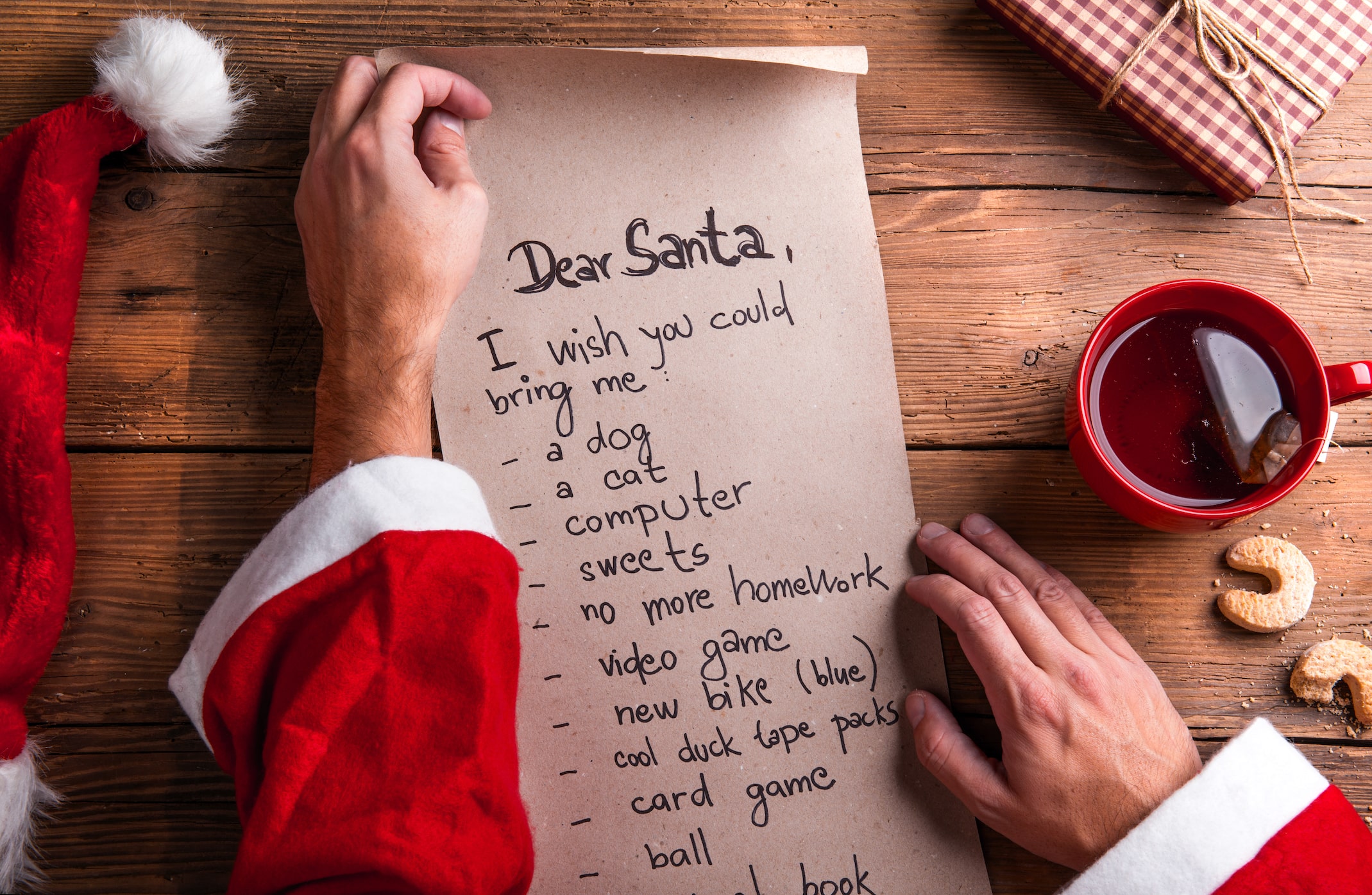 Santa Claus Holding A Wish List And Reading It SBI 305167792 Min